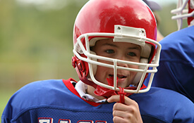 Young boy in football helmet with mouthguard